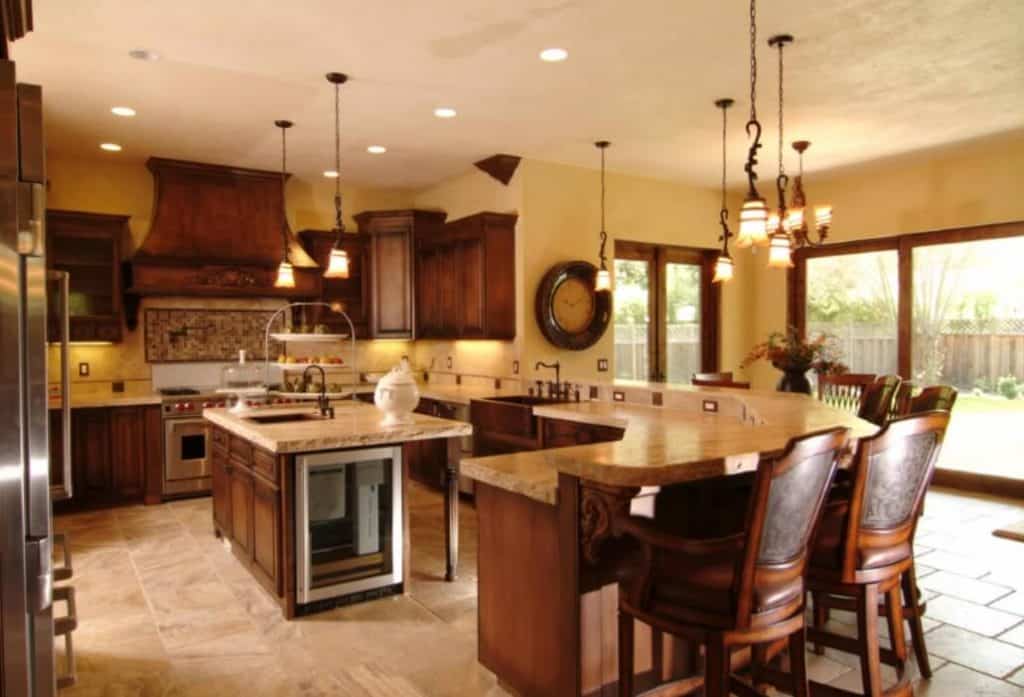 Mediterranean kitchen spanish with wood floor covering granite counters and raised wood cabinets zandart 1024x697