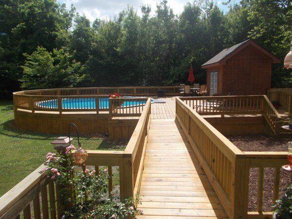 Picture Of A Circular Deck With Bridge And Above Ground Pool