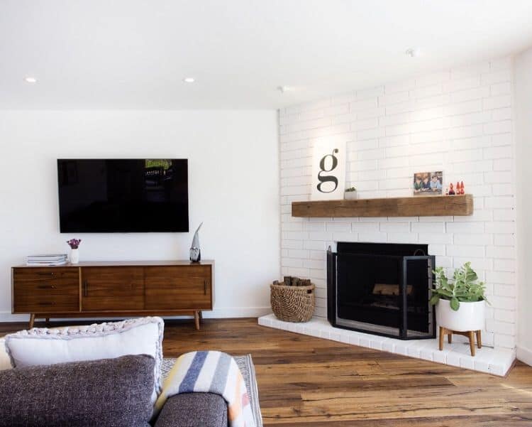 Corner Fireplace With White Brick Surround