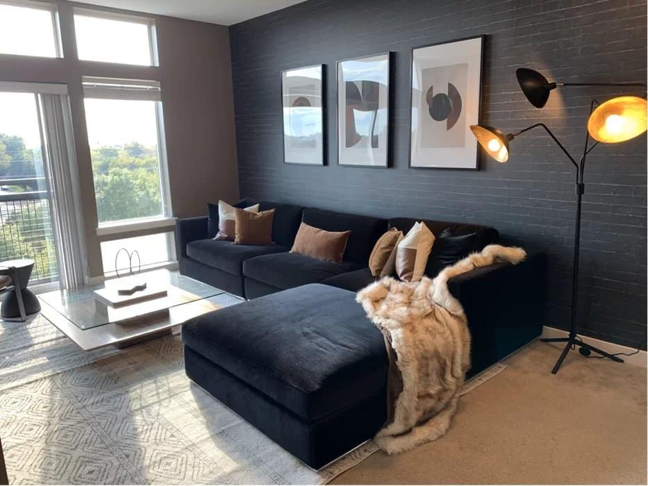 Pair A Black Couch With A Dark Grey Brick Wall